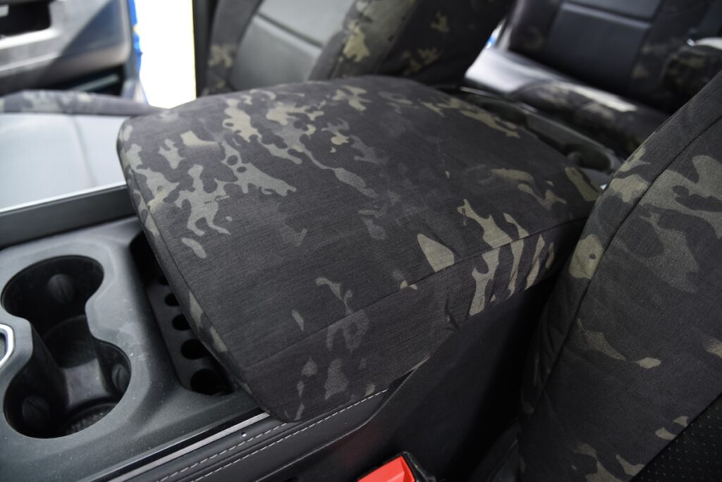 2023 RAM 2500 center console cover with MultiCam Black fabric and Black Perforated Sof-Touch seat covers
