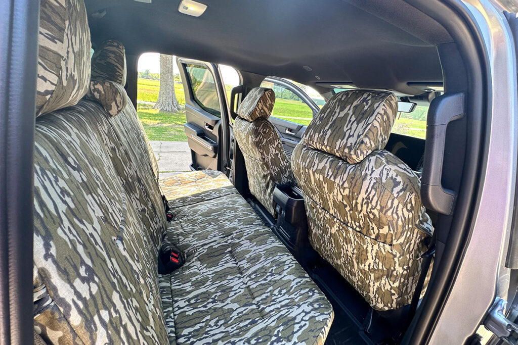 2025 Toyota Tacoma interior with front and rear Mossy Oak Bottomland camouflage seat covers