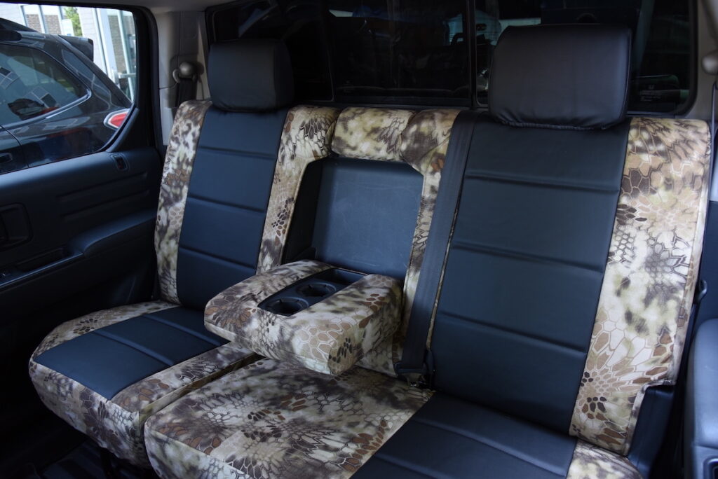 2013 Honda Ridgeline rear seat covers with center armrest in Black Sof-Touch and Kryptek Highlander
