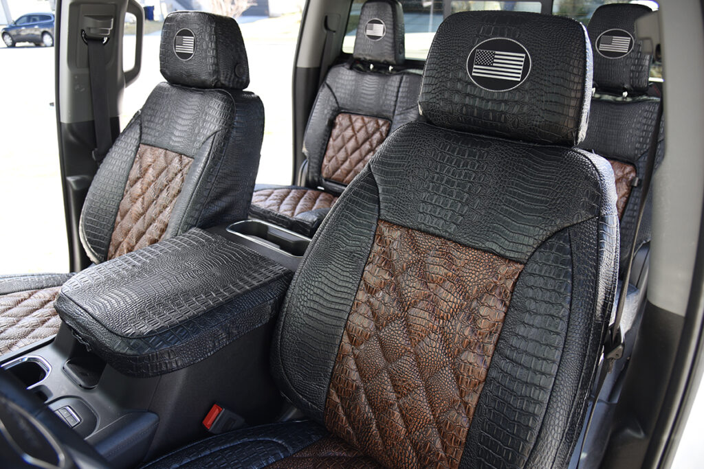 2024 GMC Sierra 3500 rear seat covers with fold-down armrest in Java Croc Diamond Stitch and Midnight Croc