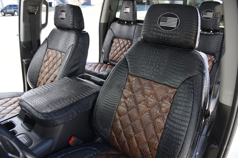 2024 GMC Sierra 3500 rear seat covers with fold-down armrest in Java Croc Diamond Stitch and Midnight Croc