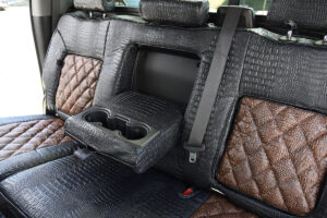 2024 GMC Sierra 3500 rear Alligator seat covers with fold-down armrest, Java Croc Diamond Stitch inserts, and Midnight Croc trim