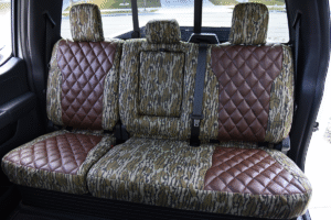 Rear seat view of 2026 Ford F-350 seat covers in Brown Ostrich Diamond Stitch leatherette and Mossy Oak Bottomland camouflage