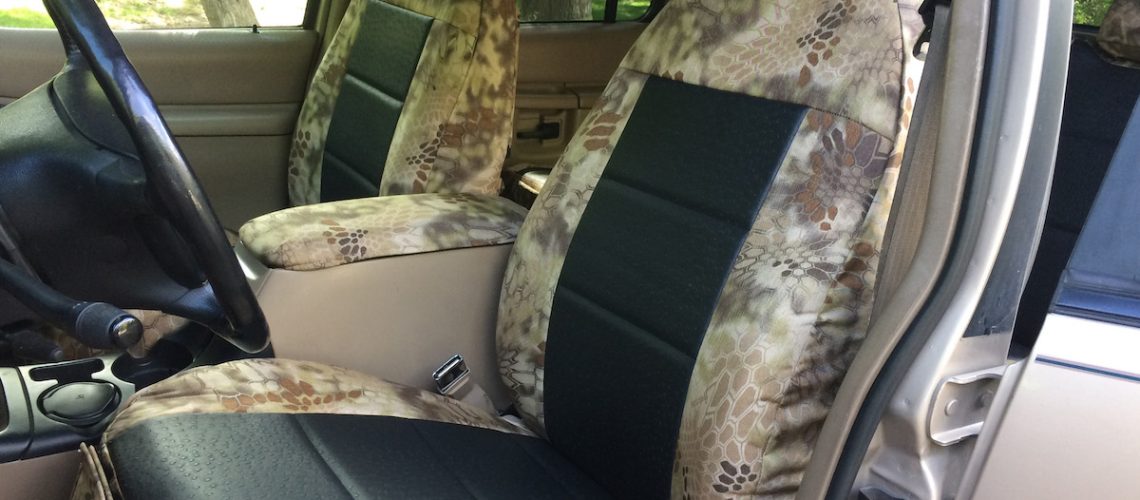 1997 Ford Explorer Black Ostrich E01 leatherette seat covers with Kryptek Highlander C70 canvas trim front seat view